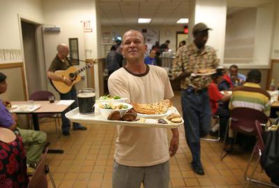 A man holds a tray of food